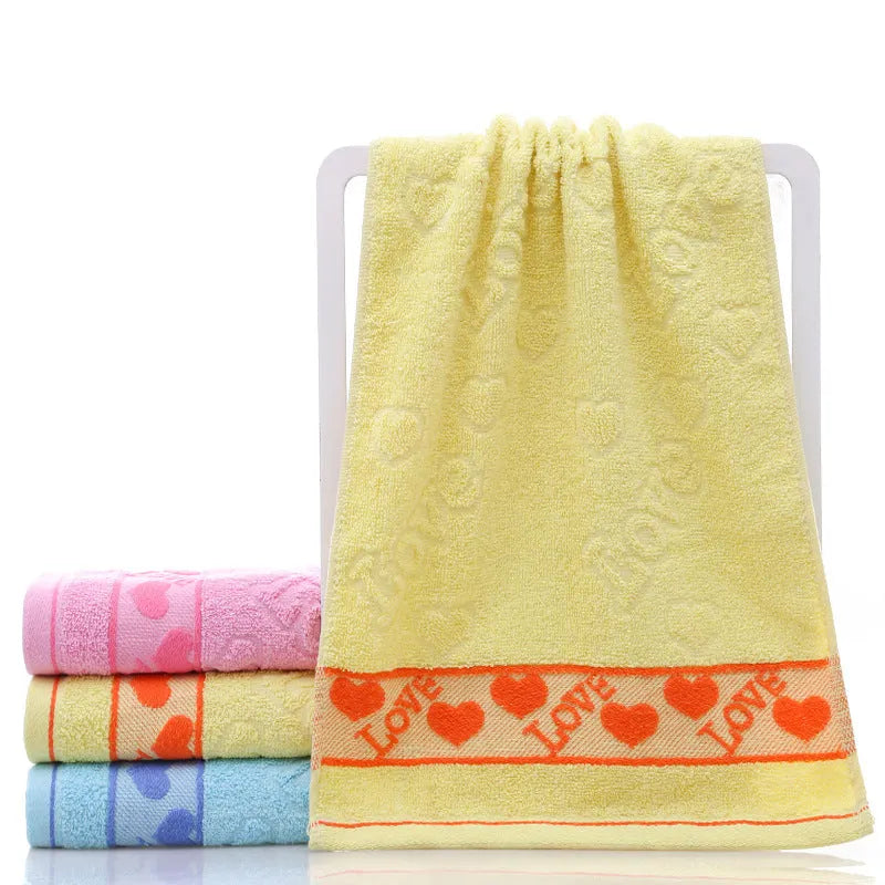 Cotton face towel 73x33cm in blue pink yellow patterns on hanger