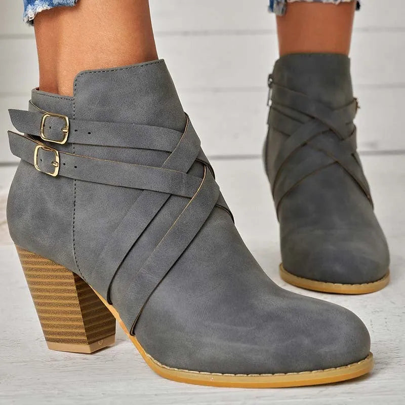 Men's black short ankle boots with side zip, belt buckle, and a 7cm heel.