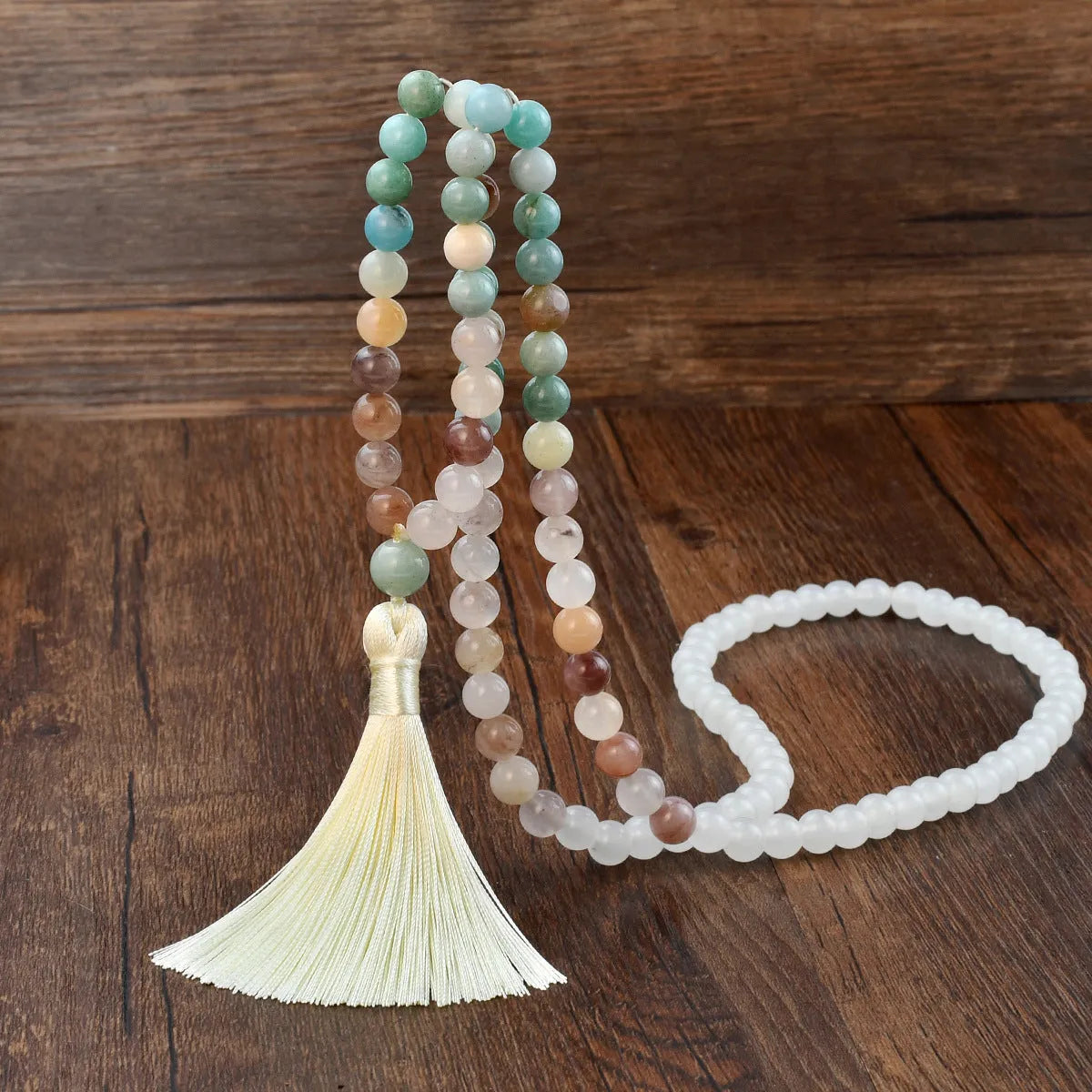 Long bohemian necklace with 108 natural stone beads, a geometric pendant, and a coloured tassel on a ball bead chain.