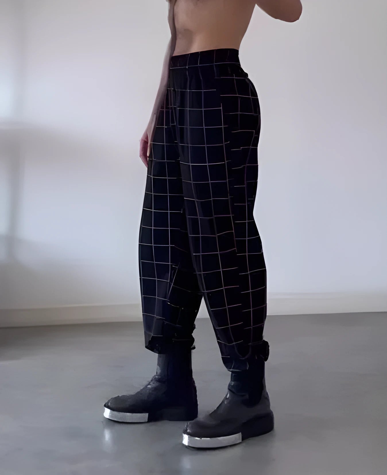 Men's plaid trousers with a full apron panel attached to the front, in a tartan pattern.