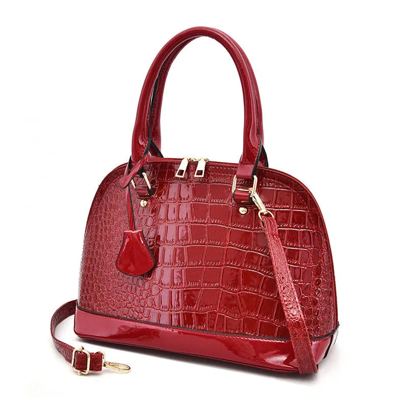 Large shiny black PU crossbody bag with a structured shell shape