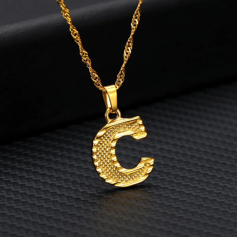 Gold-plated alloy initial pendant necklace with 42cm chain on white background