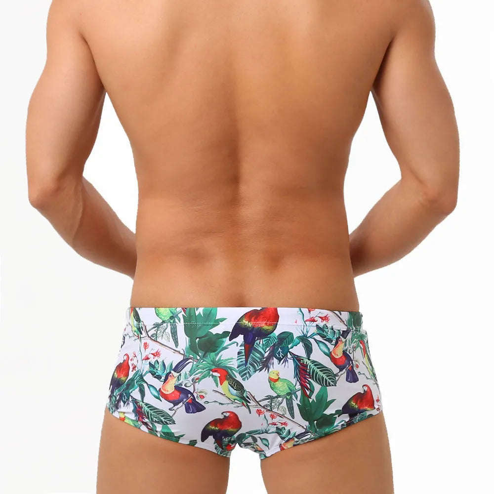 Men's floral and bird print nylon swimming trunks in boxer brief style.