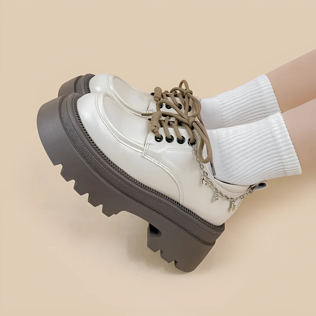 White women's platform Mary Jane shoes with a round toe, chunky high heel, and front lace-up detail.