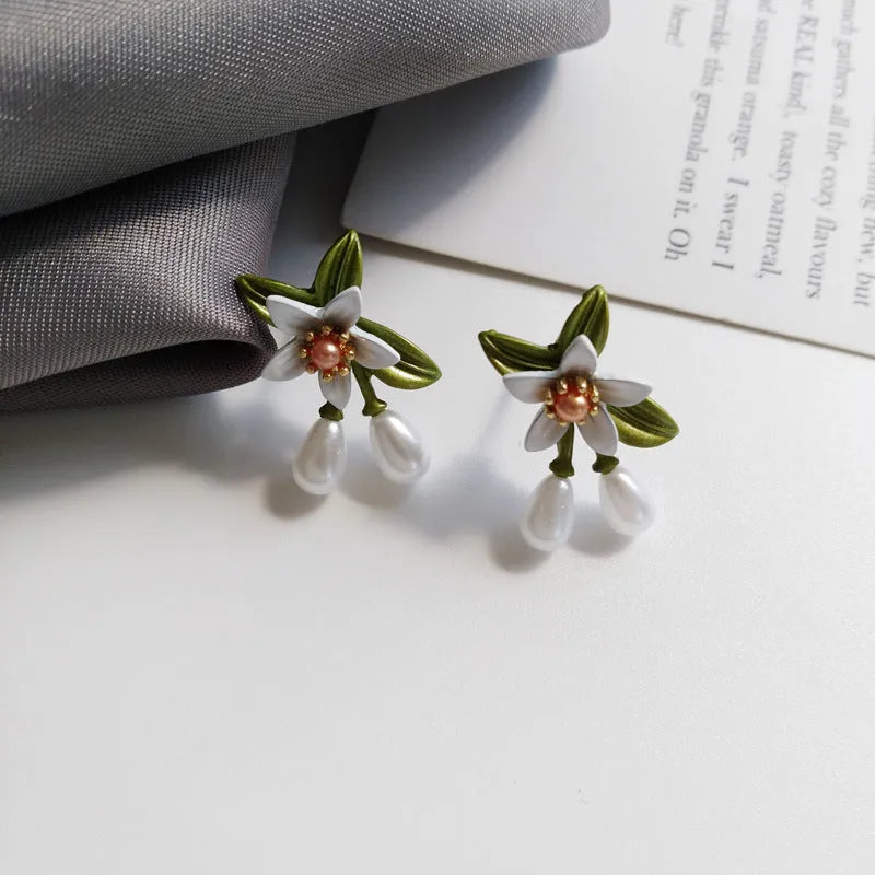 Women's sterling silver needle camellia flower earrings set with stud and clip options