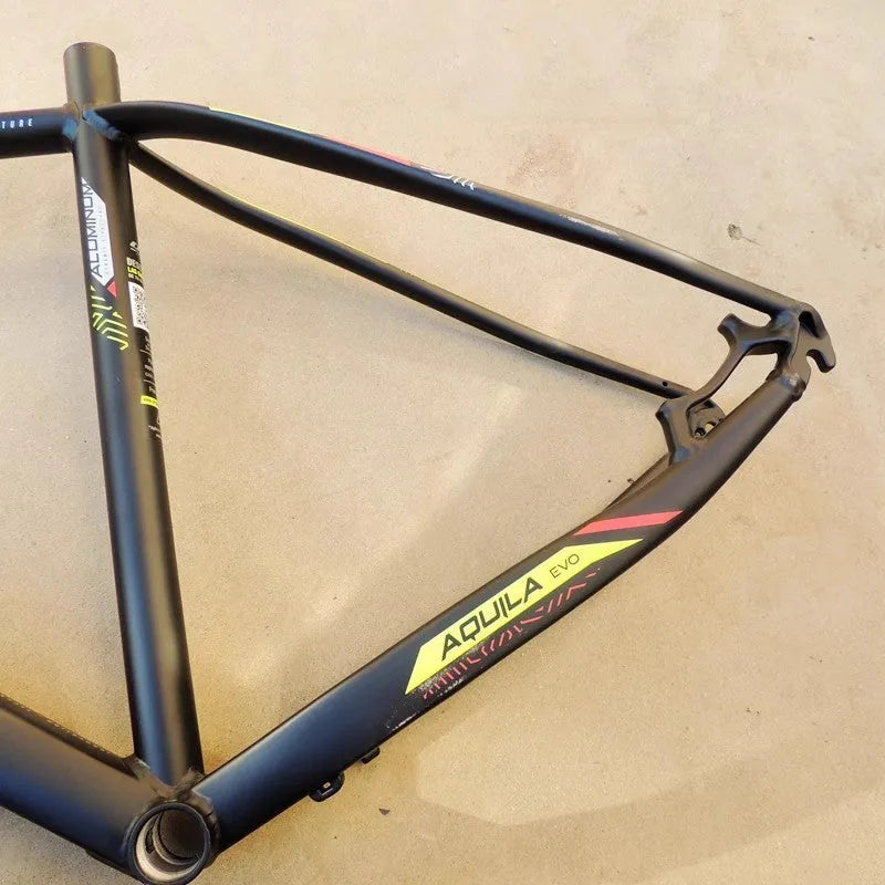 Black and green 29-inch aluminum mountain bike frame with internal cable routing and disc brake mounts