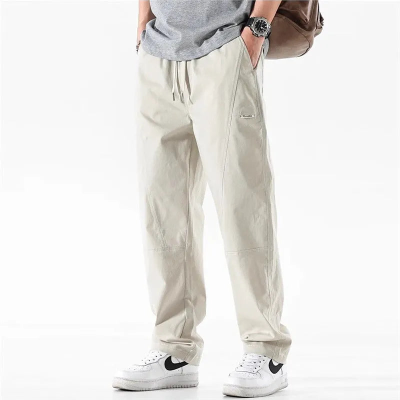 Cotton wide-leg casual trousers in Milky White hanging on a hanger, showing relaxed fit and full length.