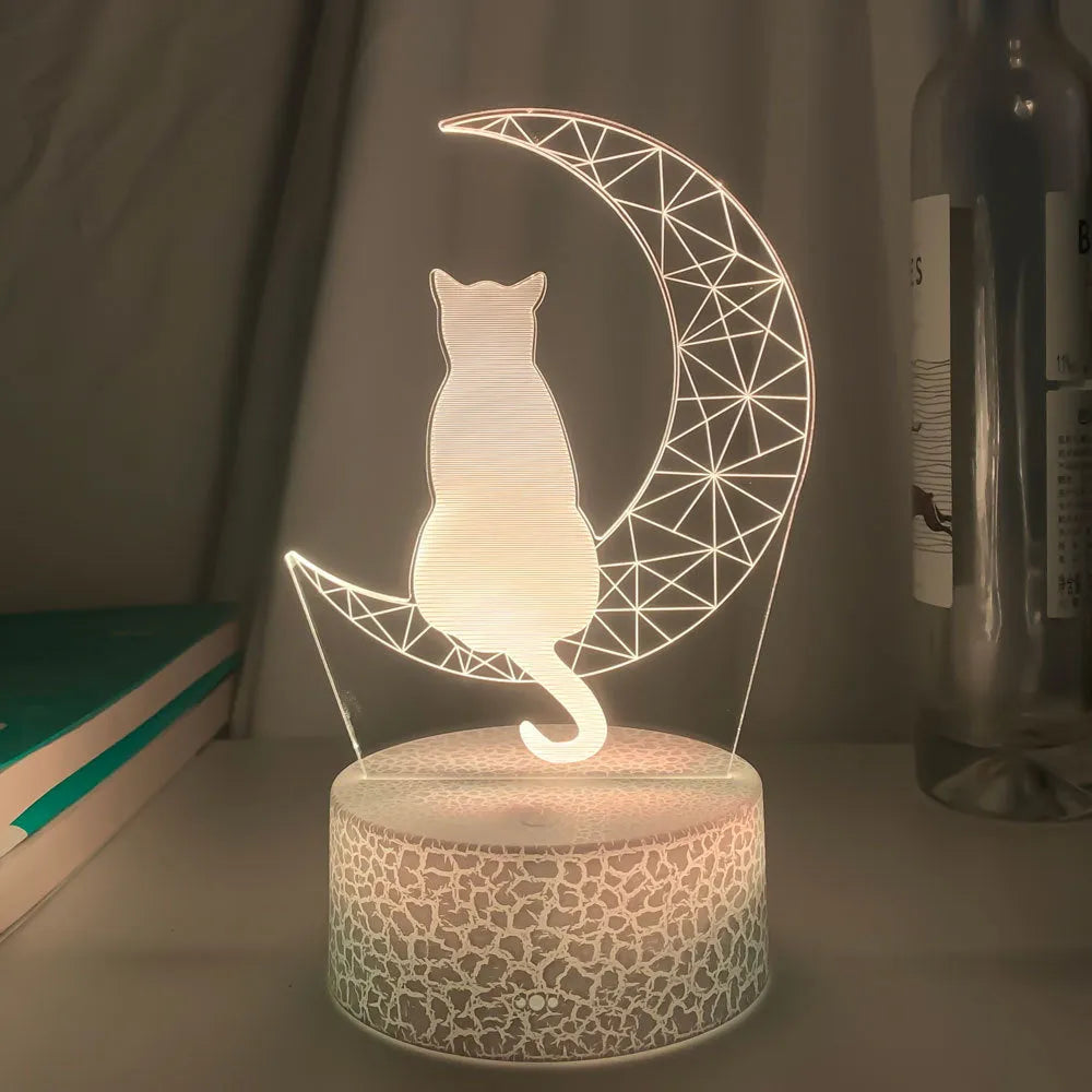 3D LED light moon and cat shape acrylic panel with remote control and USB cable on a dark surface