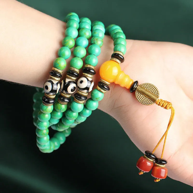 Natural raw turquoise bracelet with 108 round 8mm beads on a wrist, showing polished stone and national style design.