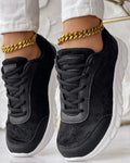 Women's white canvas running shoes with round toe and flat heel on a light background