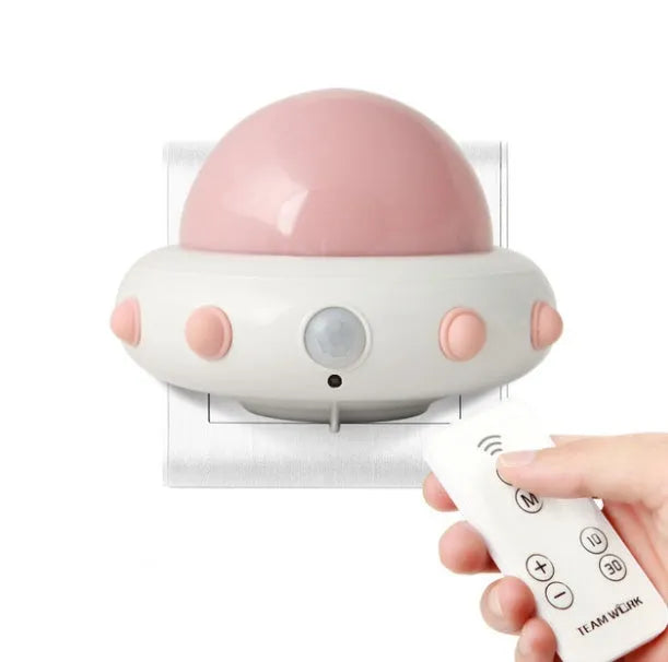 Remote control UFO shaped bedside night light in blue, pink, or white with cartoon design