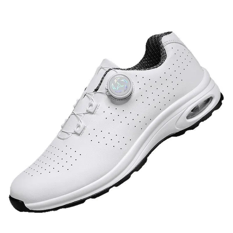 Low-top black and white tennis shoes with mesh uppers, cross shoulder straps, and a flat composite sole.