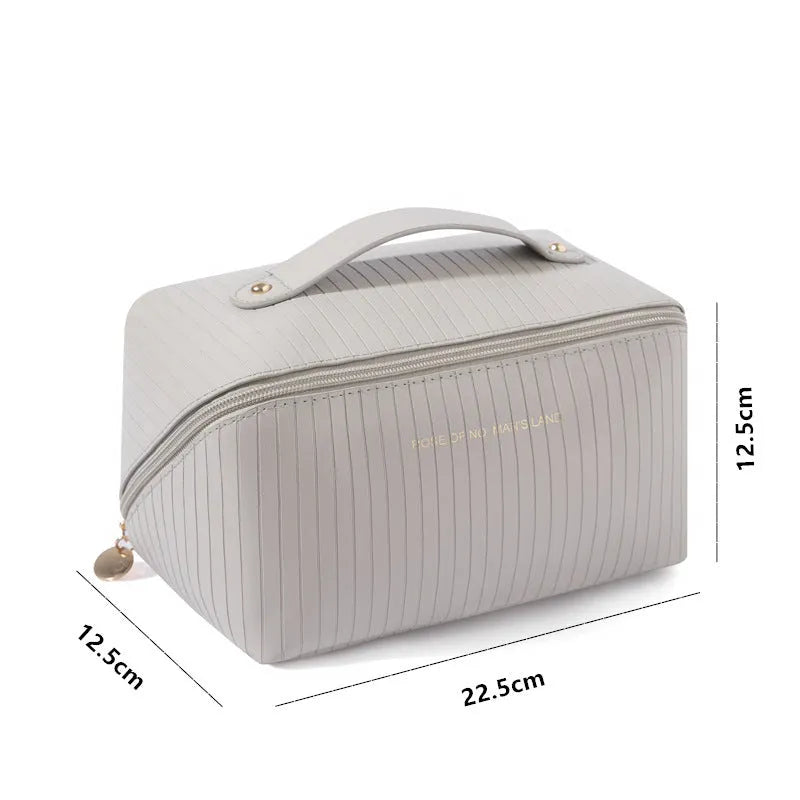 Beige cubic PU vertical pattern pillow makeup bag for travel, showing dimensions of 22.5cm by 12.5cm.