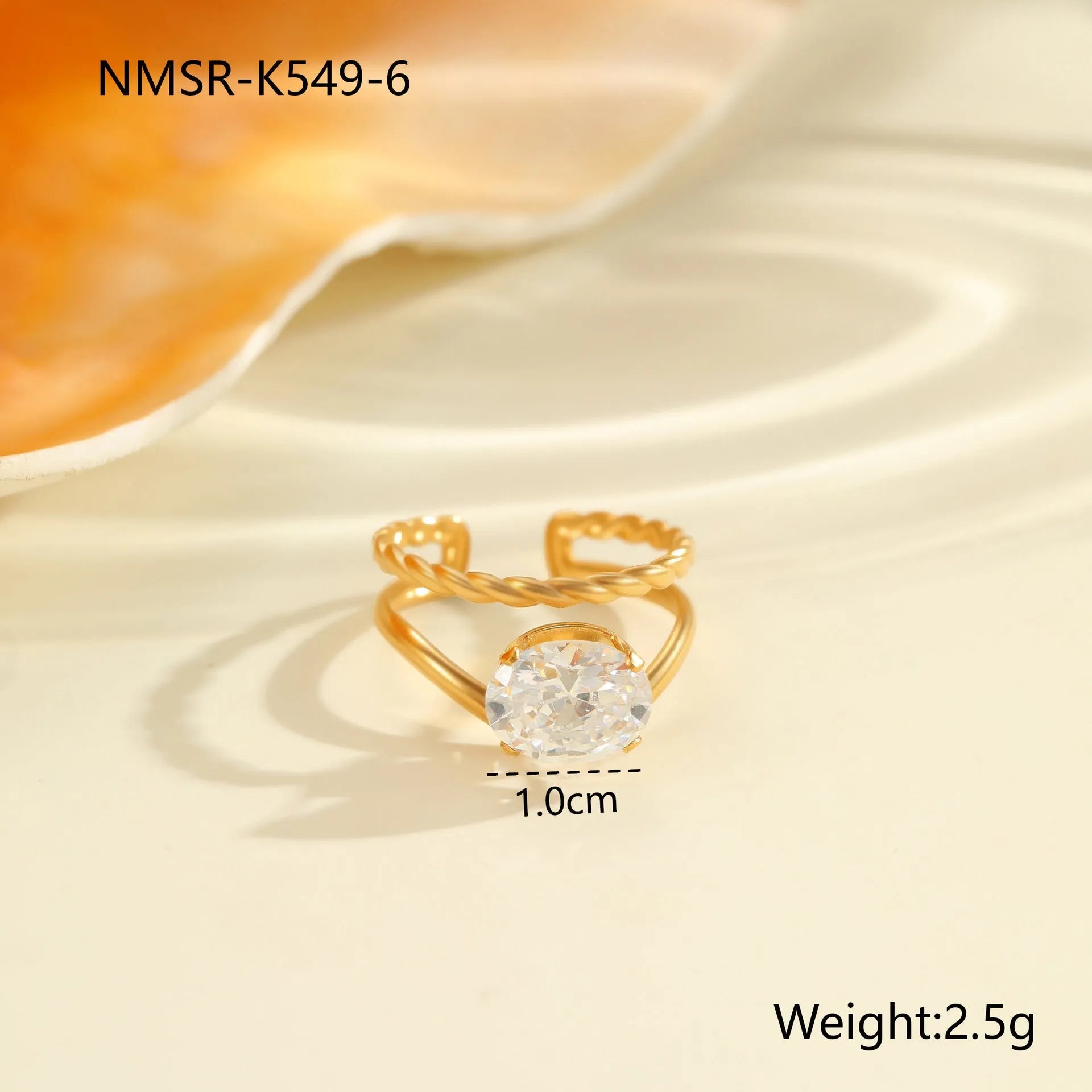 Gold-coloured adjustable stainless steel ring with zircon geometric shapes on white background.