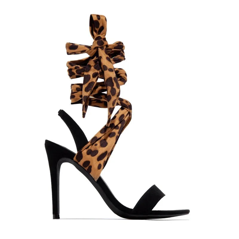 Light brown women's high heels with leopard print and Roman cross straps on a super high heel.