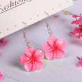 Handmade plastic resin earrings shaped like plumeria rubra flowers in a pair with multiple colour options