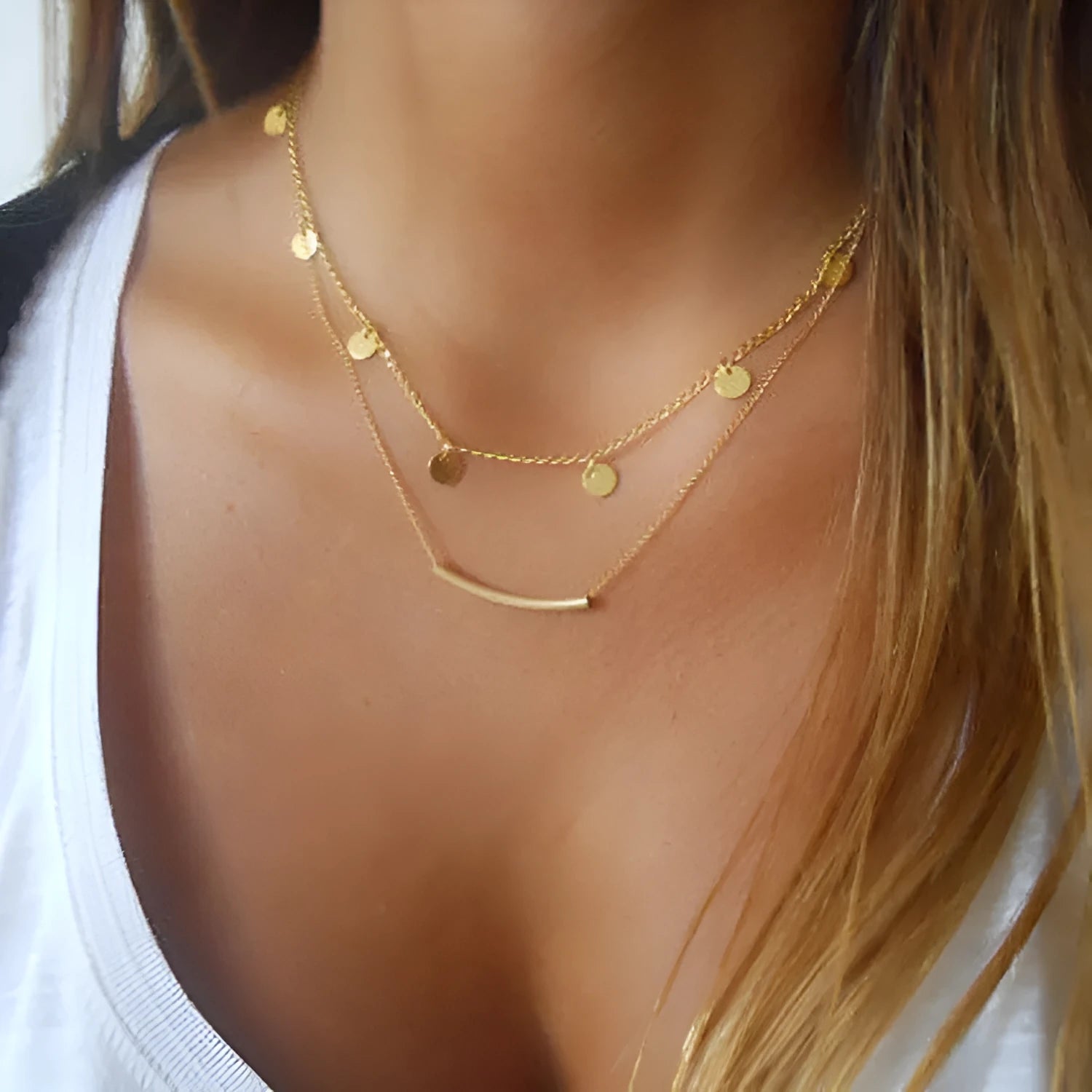 Gold alloy geometric pendant necklace with multi-sequin finish on display
