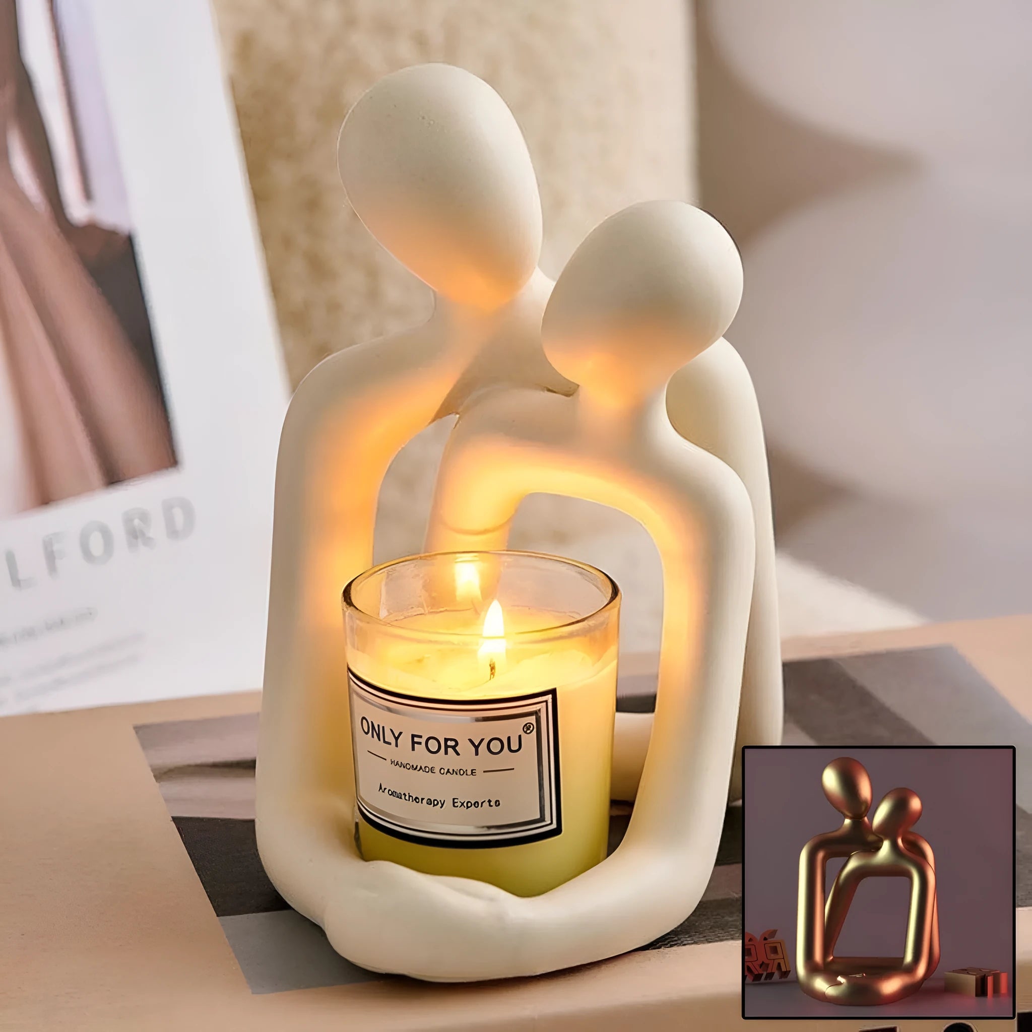 Modern style resin statue of a couple in milky white or gold colour on a wooden surface.