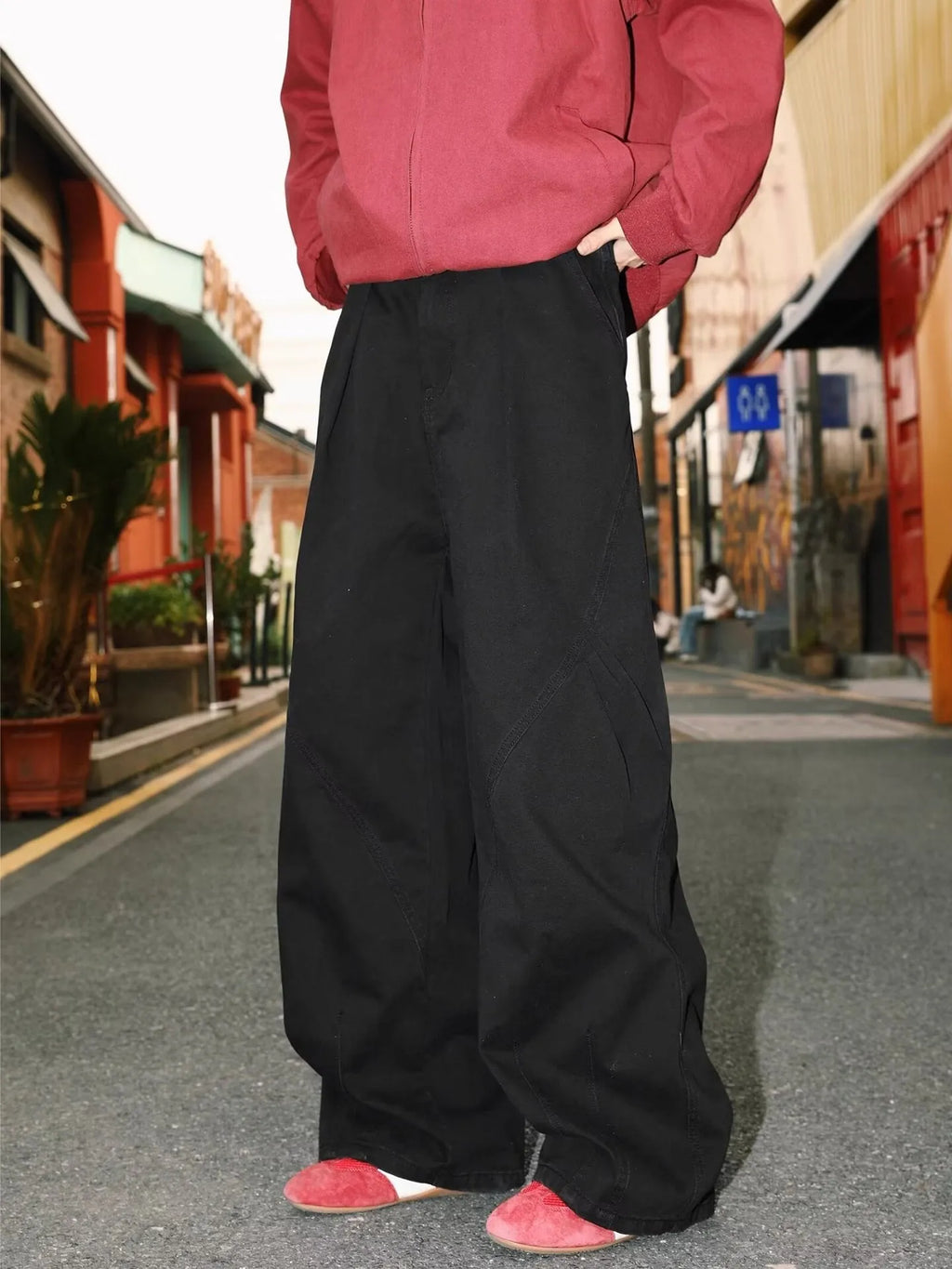 Men's pleated straight loose trousers in black striped pattern showing straight leg design