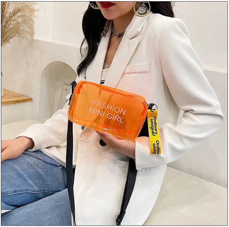 Clear square jelly shoulder bag with adjustable strap in various colours on a white background.