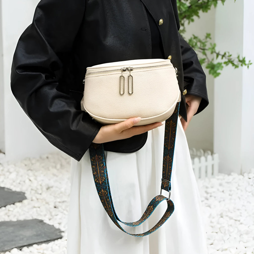 Women's soft PU messenger bag in saddle shape with single shoulder strap and internal organisation
