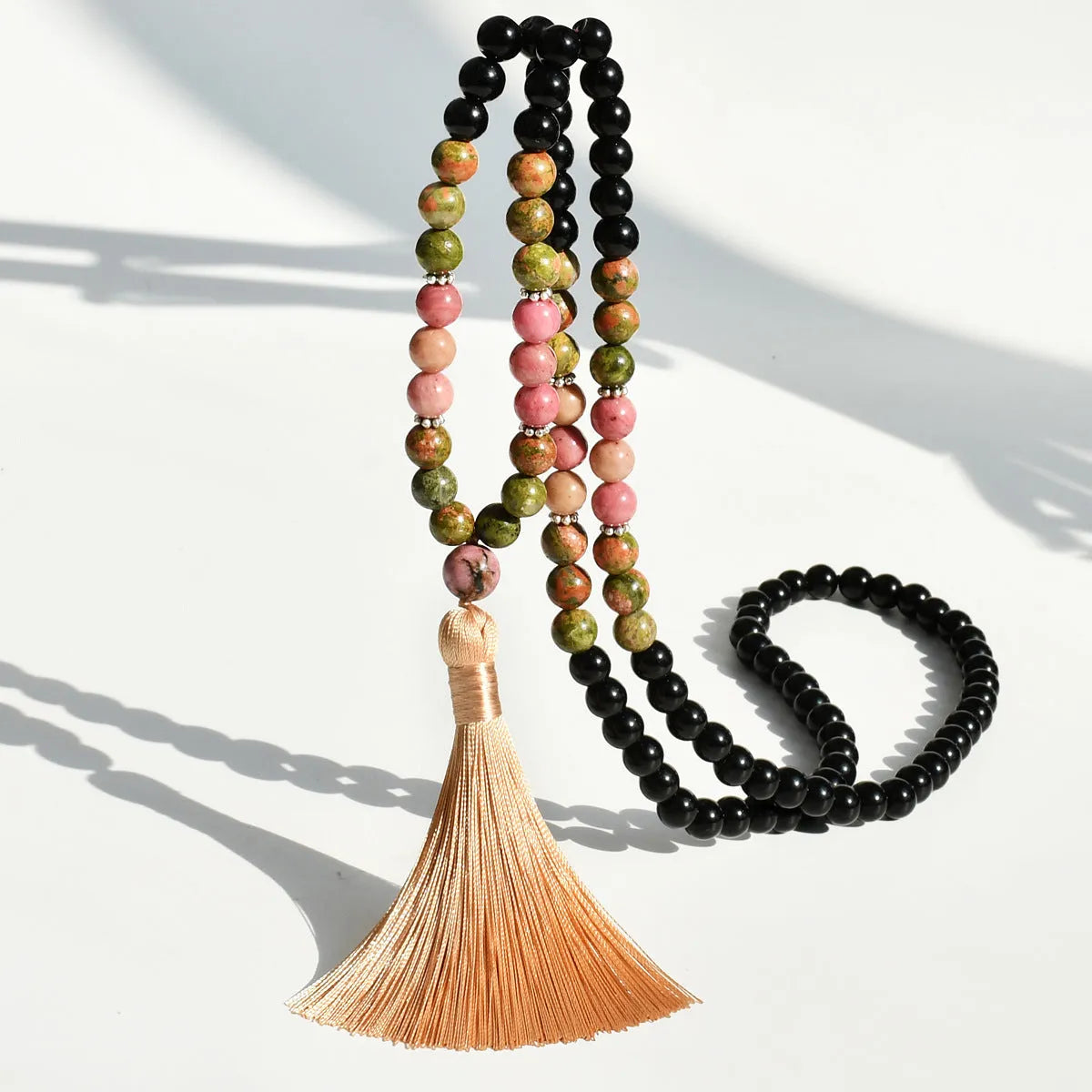 Long bohemian necklace with 108 natural stone beads, a geometric pendant, and a coloured tassel on a ball bead chain.