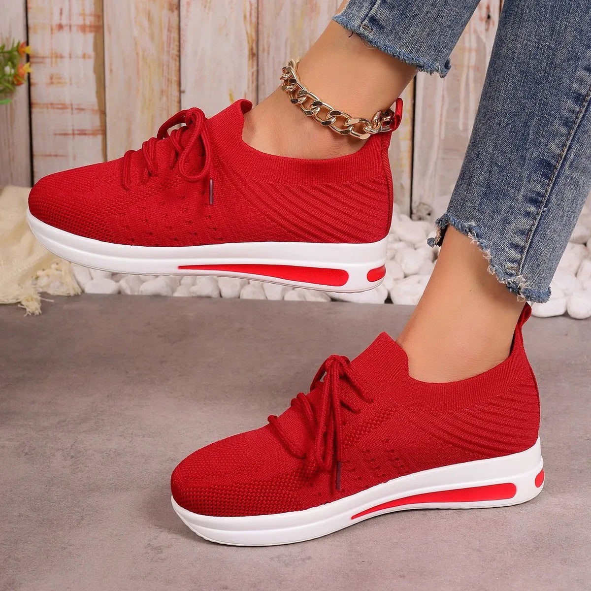 Women's red fly-knit casual sneakers with round toe and lace-up front.
