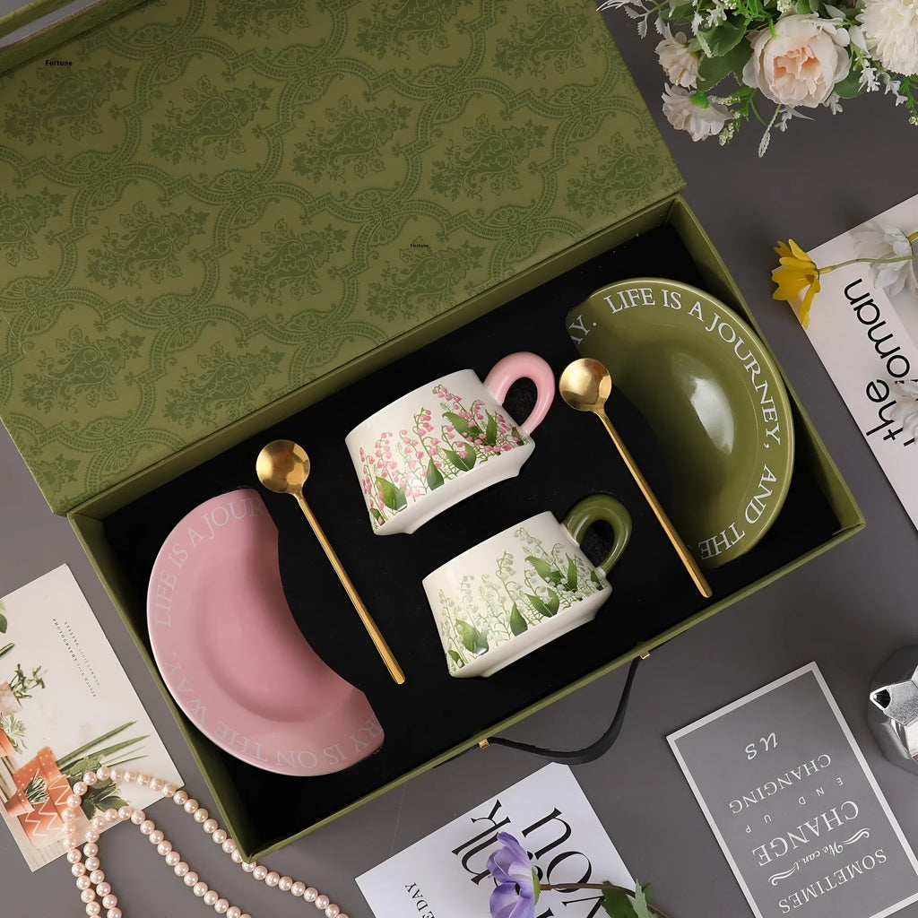Ceramic coffee cup and saucer set for couples with stirring spoons in two design options.