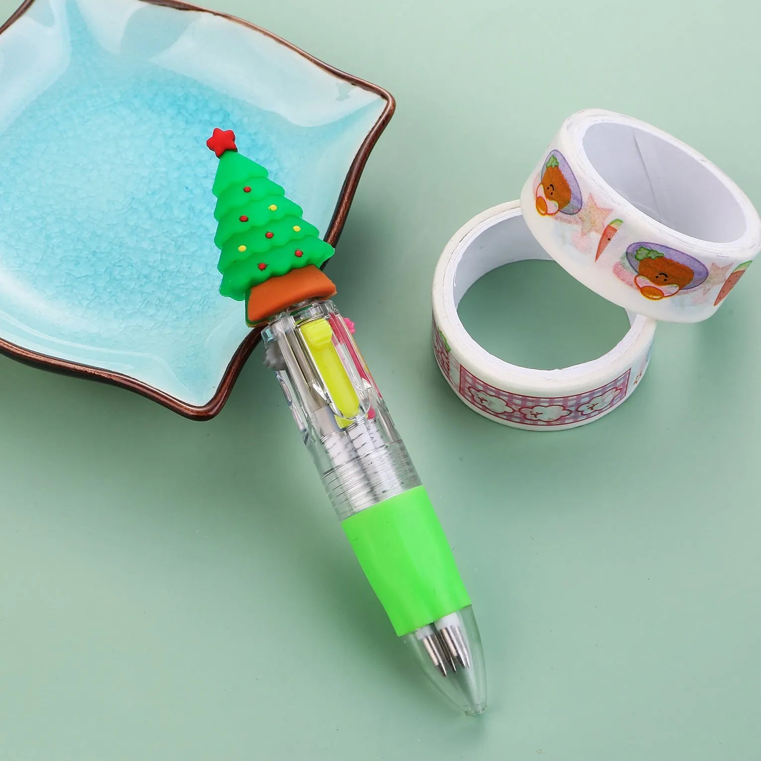 Compact 11cm Christmas-themed press-action ballpoint pen with festive designs.