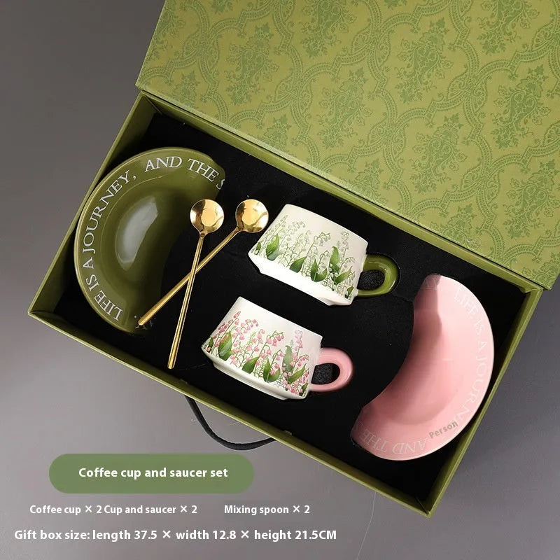 Ceramic coffee cup and saucer set for couples with stirring spoons in two design options.