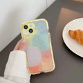 Minimalist iPhone 14 silicone case with a yellow edge on a dark background.