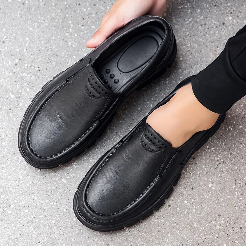 Men's black slip-on work shoes with a mid-top waterproof artificial leather upper and platform sole.