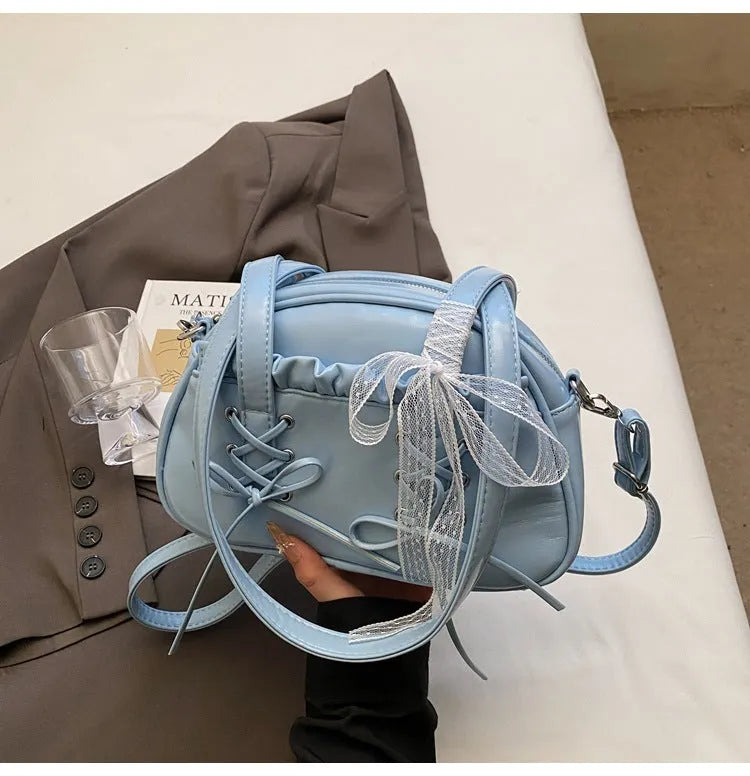 Ladies shoulder handbag with bandage bow design in PU leather showing phone pocket compartment
