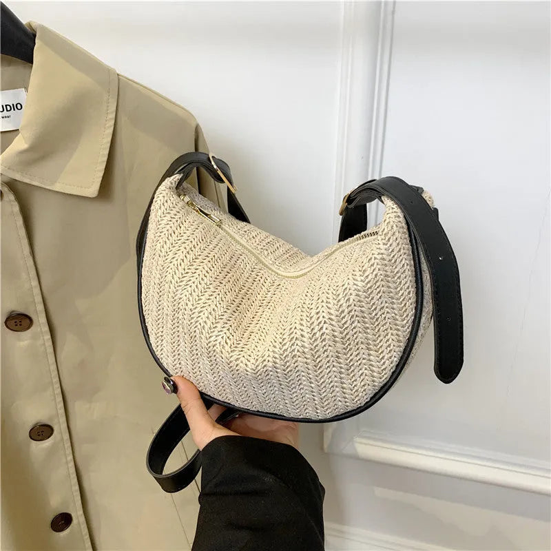Straw woven crossbody bag showing woven texture and interior phone compartment