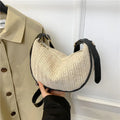 Straw woven crossbody bag showing woven texture and interior phone compartment