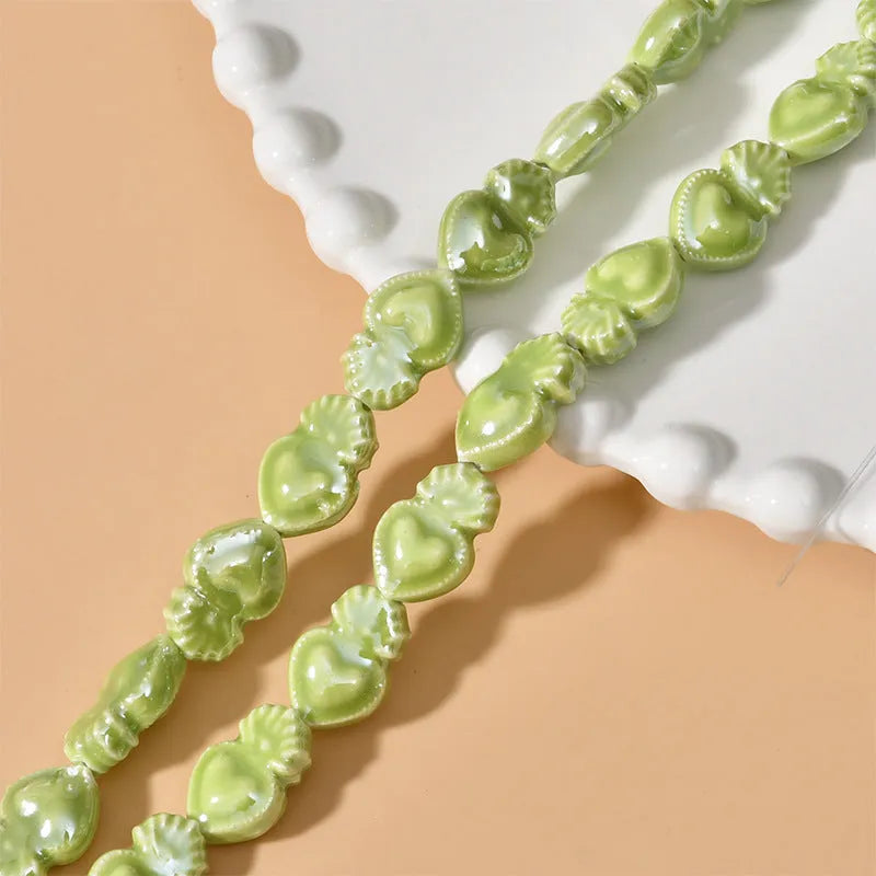 Ceramic heart torch beads in various colours for jewellery making, approximately 10mm by 15mm with straight hole