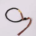Hand-woven obsidian carrying strap bracelet showing textured surface and 4mm width