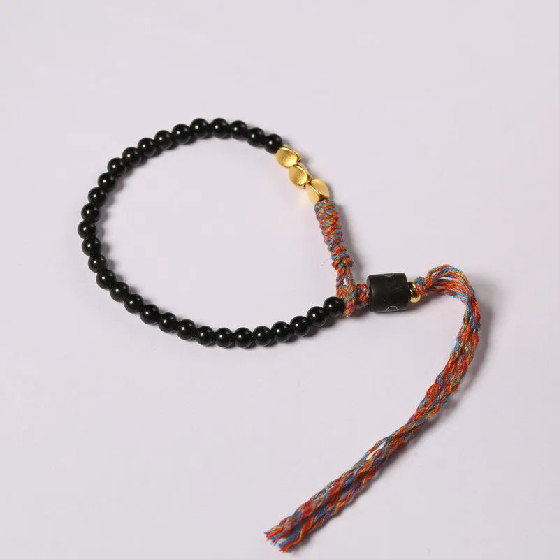 Hand-woven obsidian carrying strap bracelet showing textured surface and 4mm width