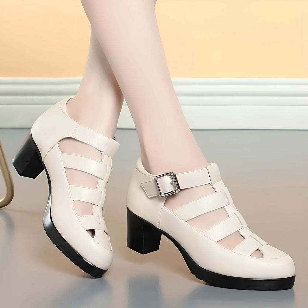 Women's beige closed toe sandals with chunky heel, ankle strap, buckle, and back zipper.