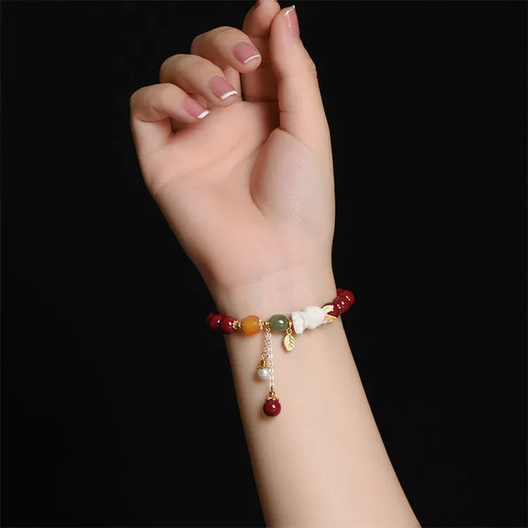 Natural red cinnabar bracelet for women featuring a carved rabbit design, shown in 8mm and 10mm width options.