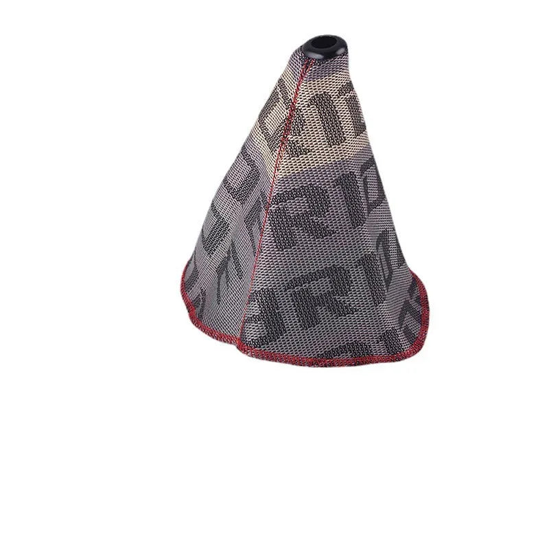 Canvas dust cover draped over a racing bucket seat in a vehicle interior.