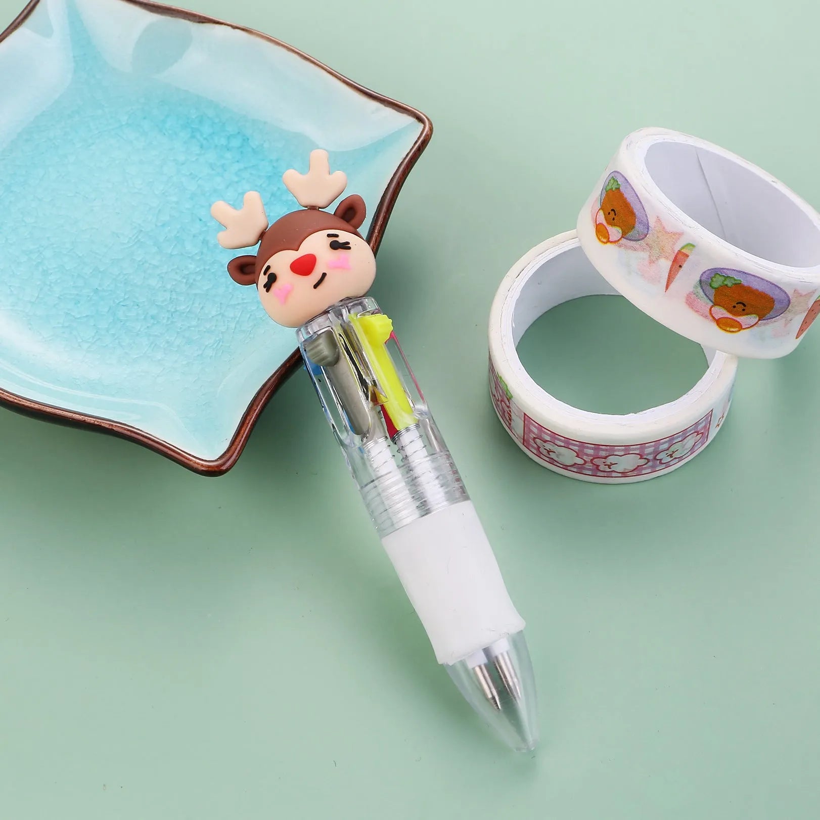 Compact 11cm Christmas-themed press-action ballpoint pen with festive designs.