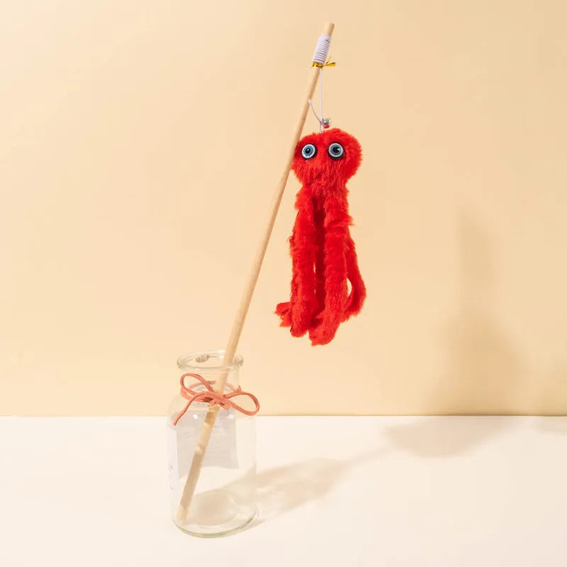 Grey furry octopus cat toy with eyes on a long stick for interactive indoor play with kittens.