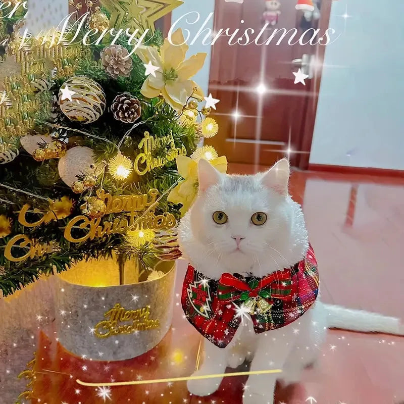 Polyester pet scarf cloak on a dog, showing a red background with a festive snowflake bell design.