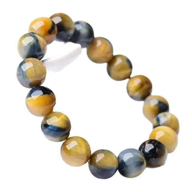 Fantasy Tigereye agate beaded bracelet with round geometric beads on a wrist, showing natural stone colour.