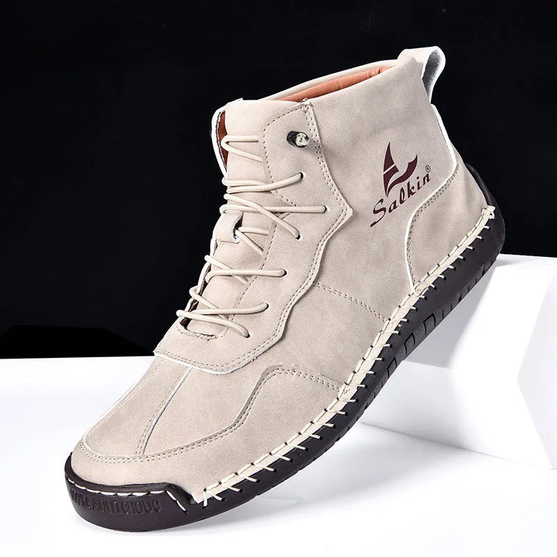 Casual high-top leather boots with elastic band closure and flat heel in beige colour with visible sewing detailing