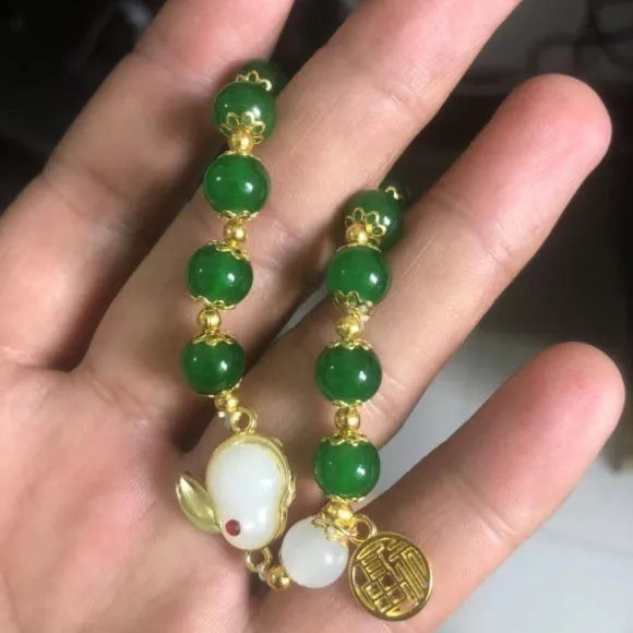 Chinese style glass bracelet with bamboo joint details in a red Lvzhu Duobao design.