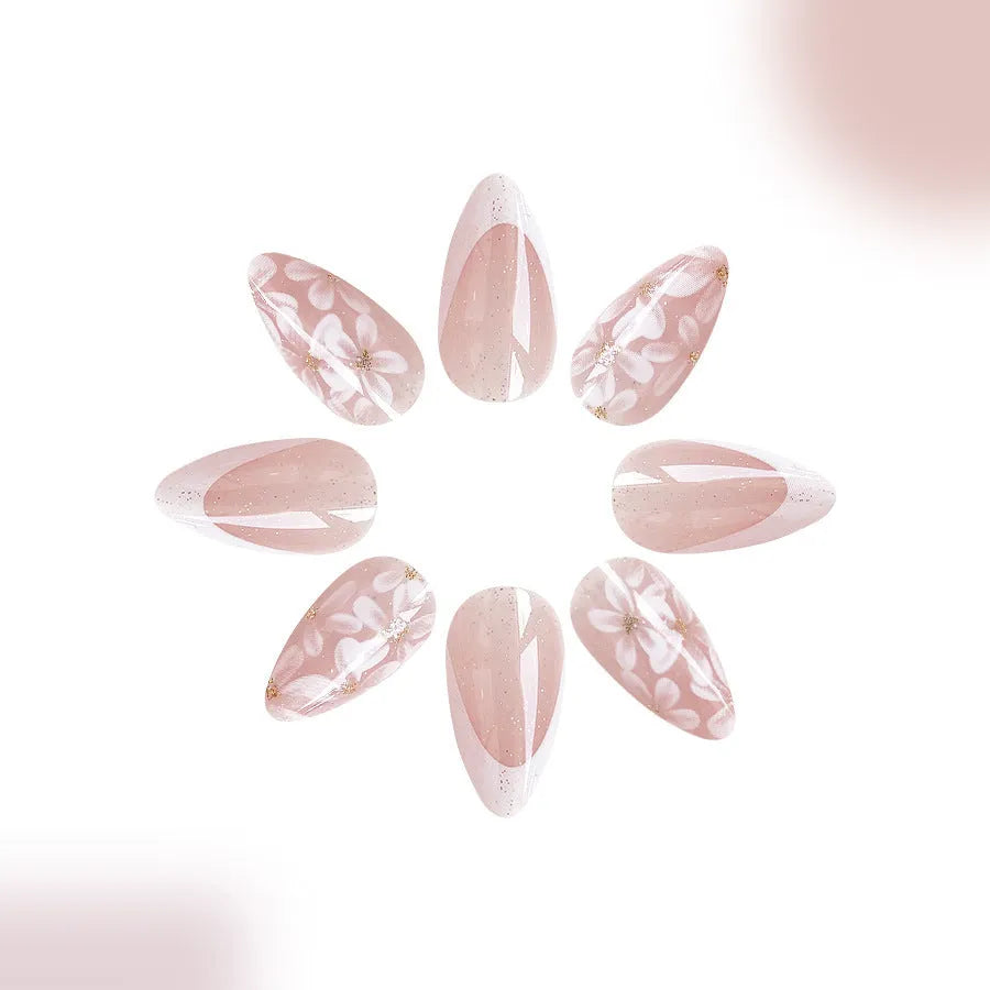 Short almond shaped artificial nails with French style and glittering powder flower design in C625 colour