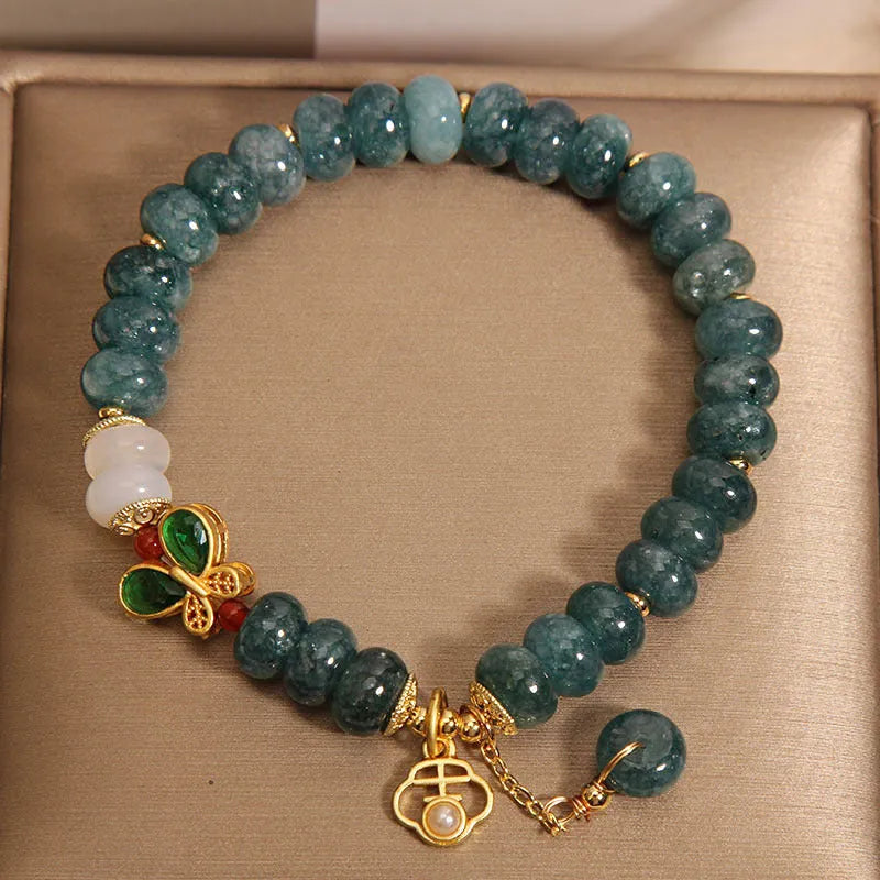 Blue water jade abacus bead bracelet with white agate and butterfly charm design