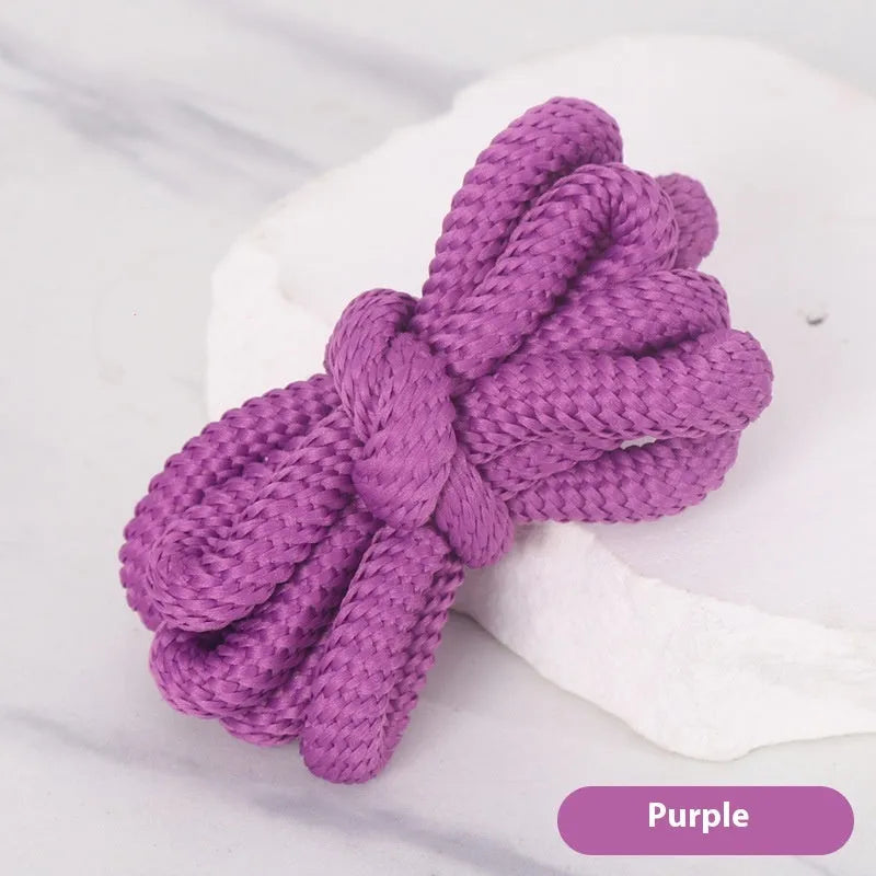 Oval cross-section shoelace adapter rope in various colours, shown next to a trainer and sweatshirt.